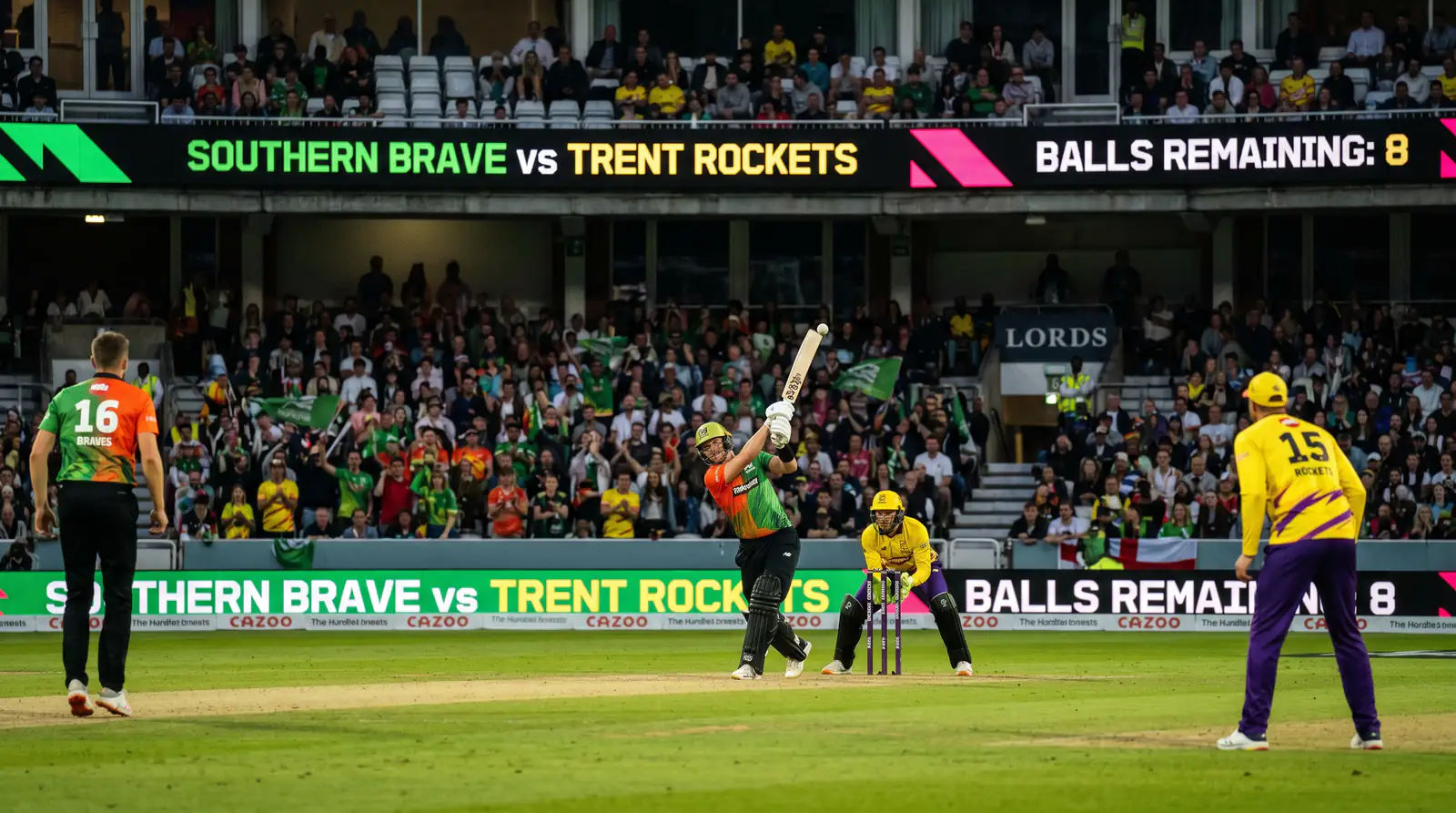 The Hundred cricket match in progress at a packed English ground under floodlights