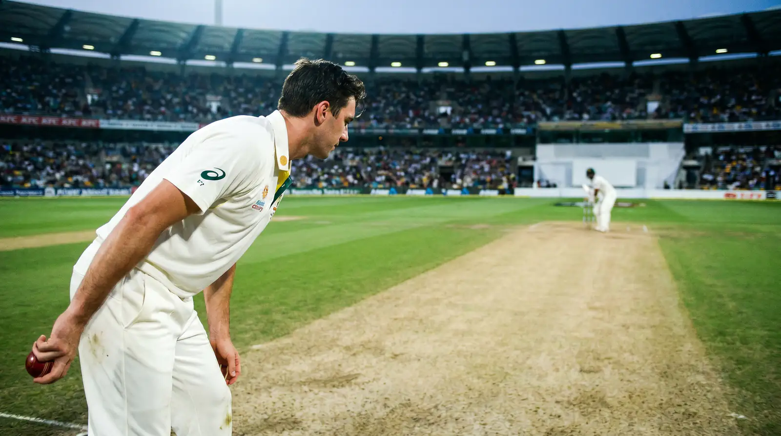 Left-arm pace bowler at the top of the run-up preparing to deliver the new ball in a T20 powerplay