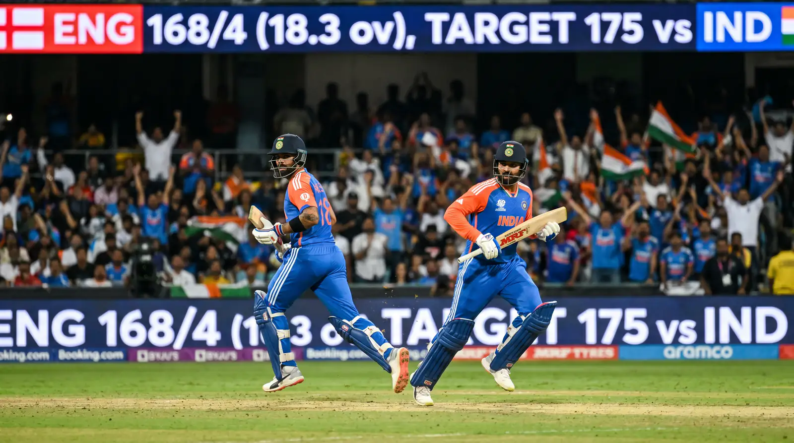 T20 opening batsmen running between wickets aggressively during a second-innings powerplay chase