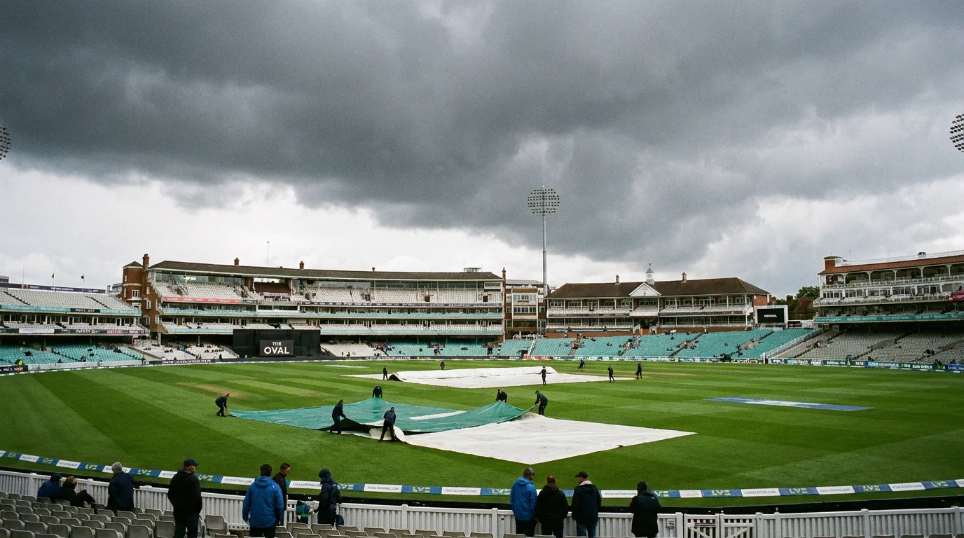 Cricket ground under dark clouds with rain covers partially pulled across the pitch area
