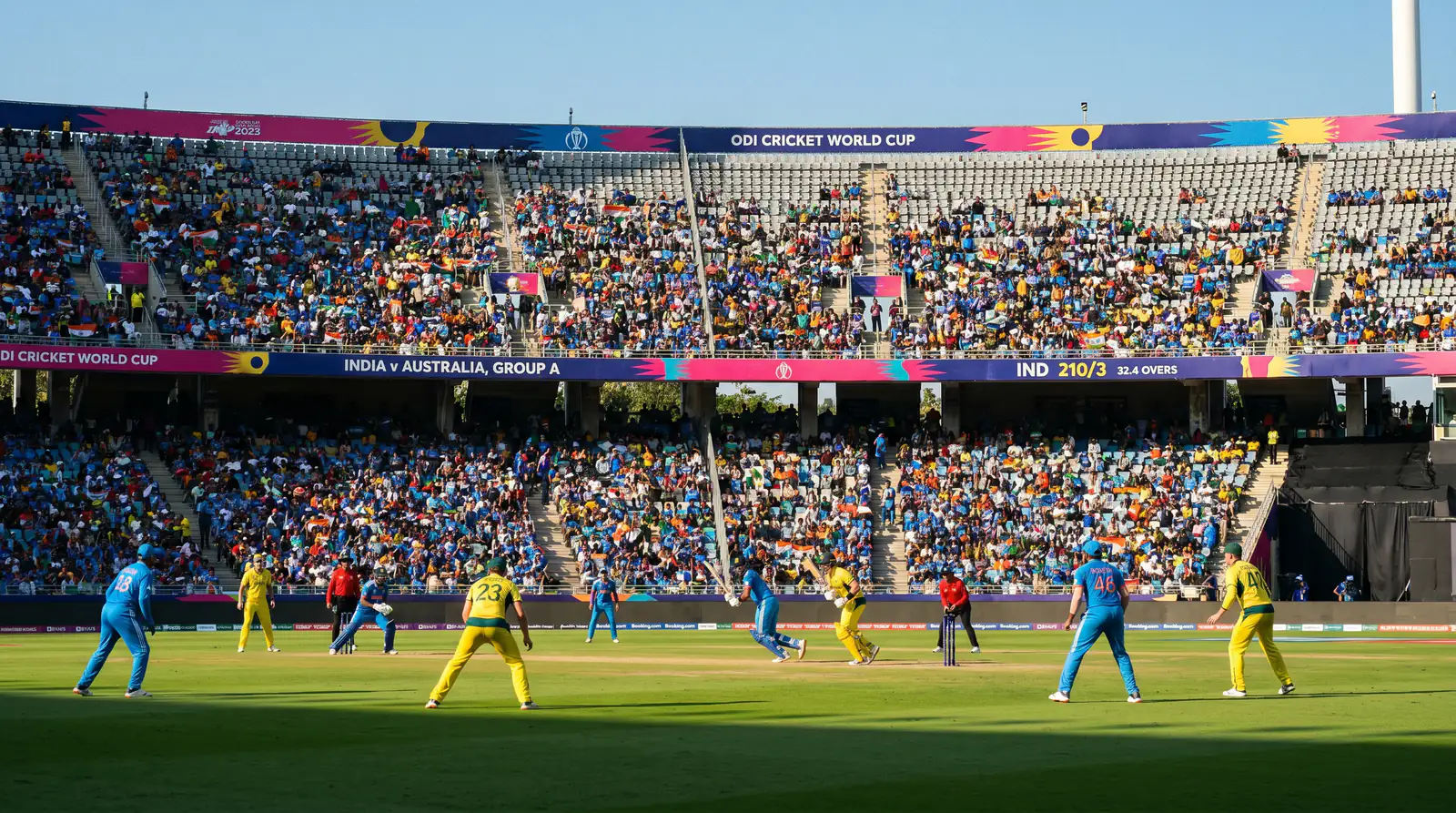 Two World Cup teams contesting a group-stage match at a neutral venue with scattered crowd